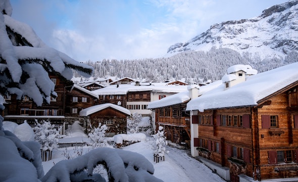 Beautiful snow-covered chalet with a mountain backdrop