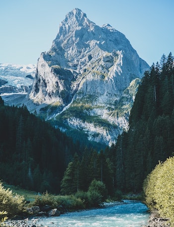 View of a snow-covered Swiss mountain peak under a clear blue sky